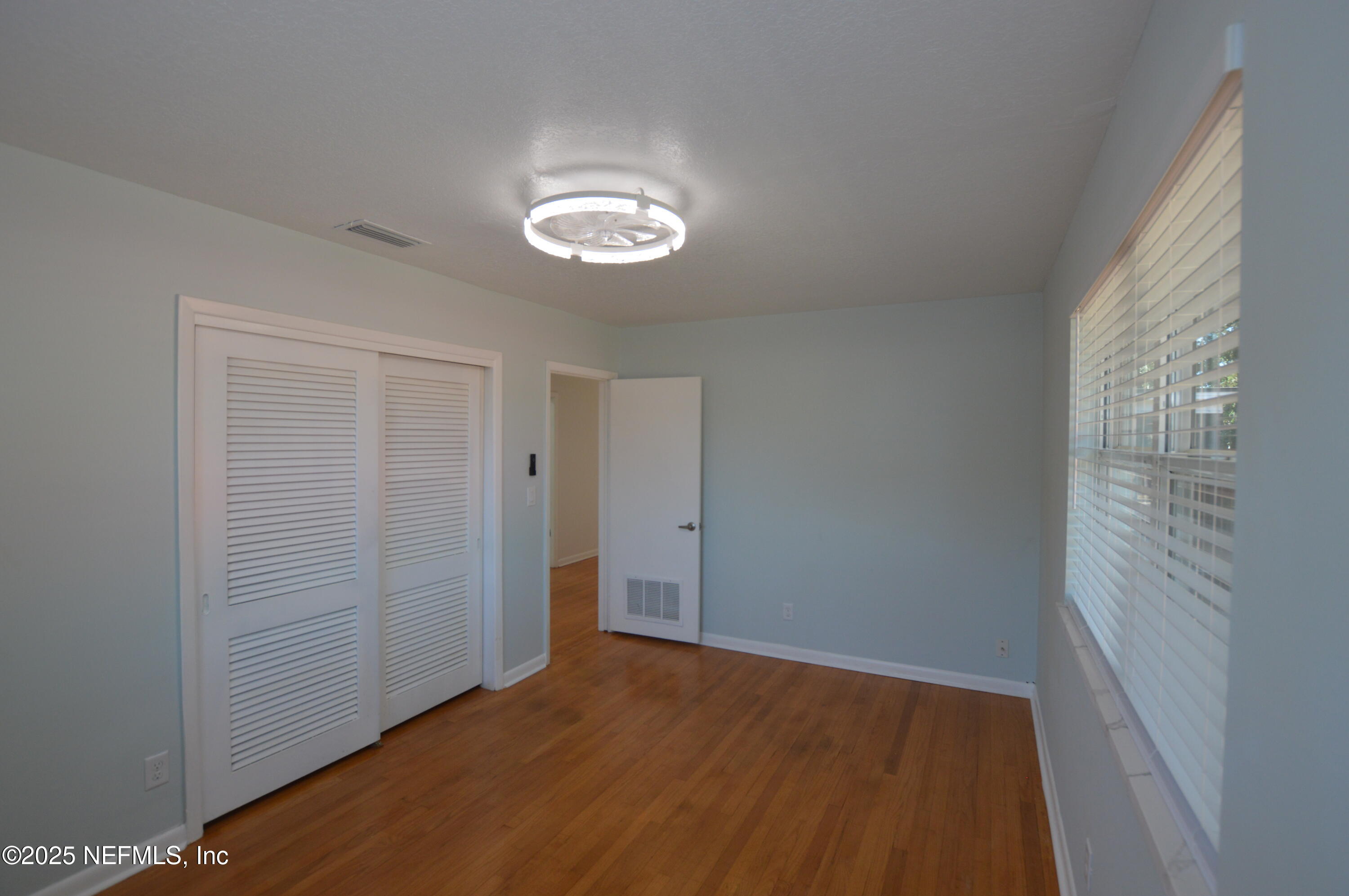 7941 Alderman Road Jacksonville, FL 32211 - Photo 21 of 40 an empty room with wooden floor and windows