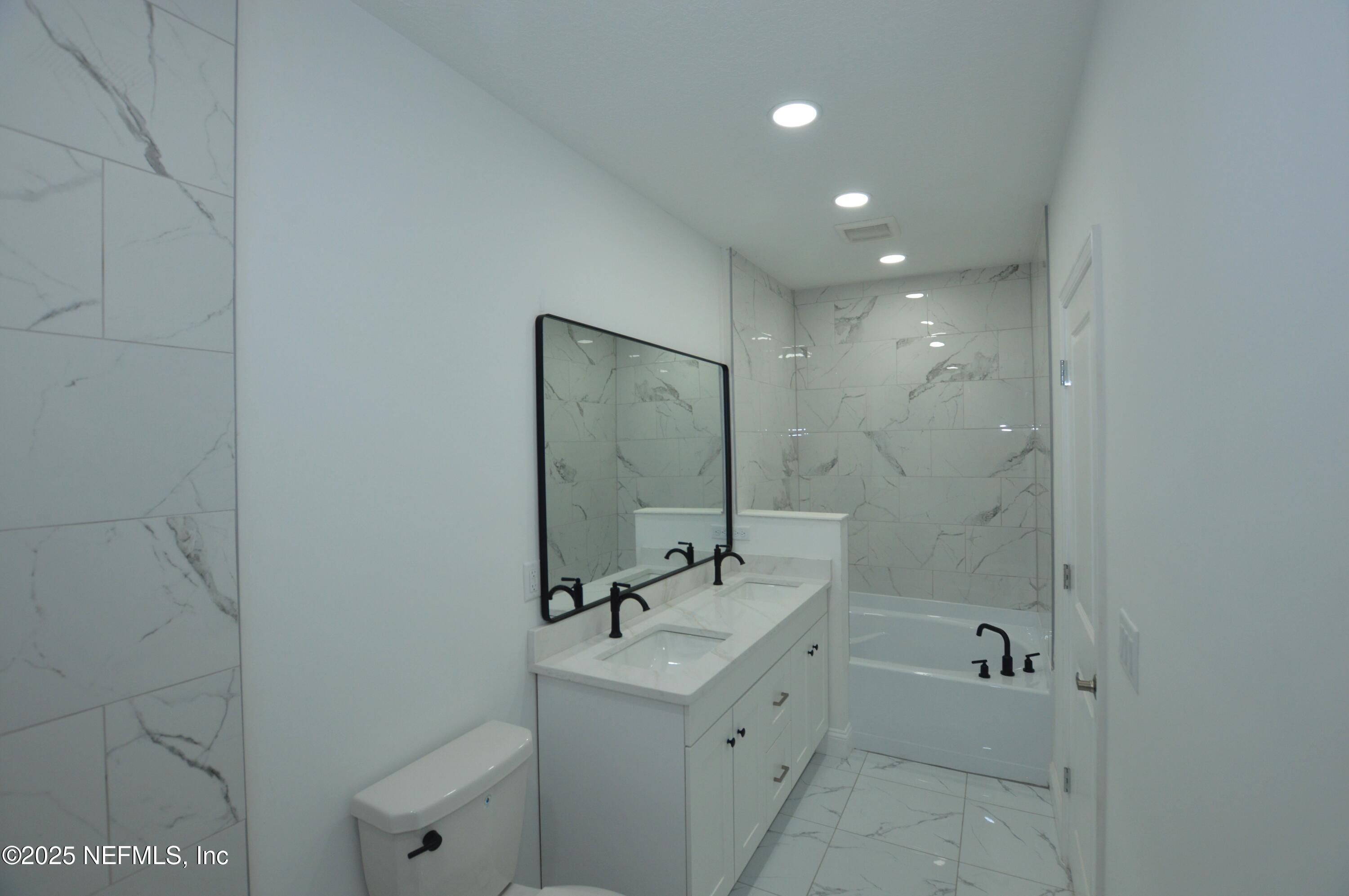 7941 Alderman Road Jacksonville, FL 32211 - Photo 28 of 40 a bathroom with a sink a toilet and shower