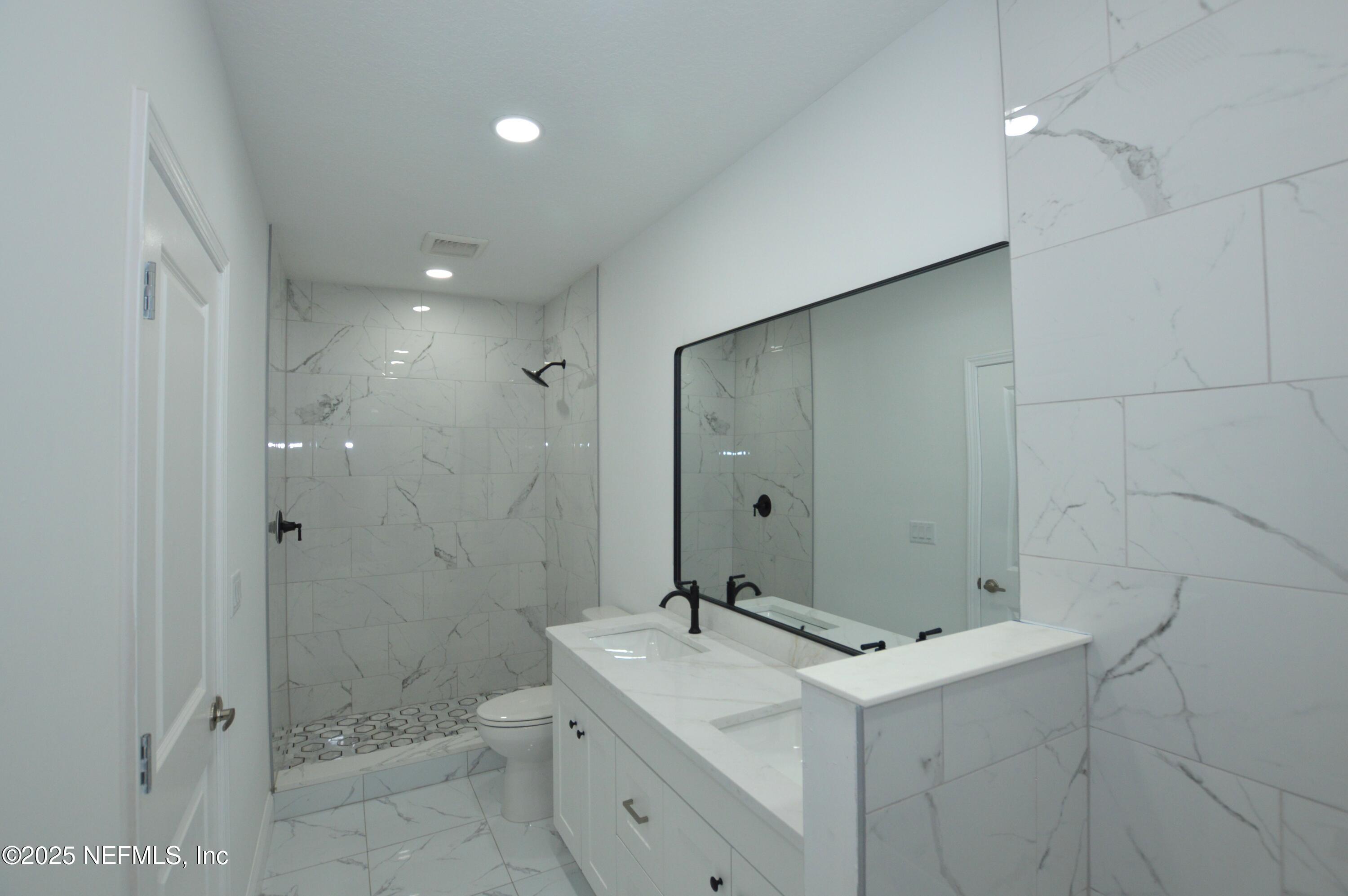 7941 Alderman Road Jacksonville, FL 32211 - Photo 29 of 40 a bathroom with a sink and mirror