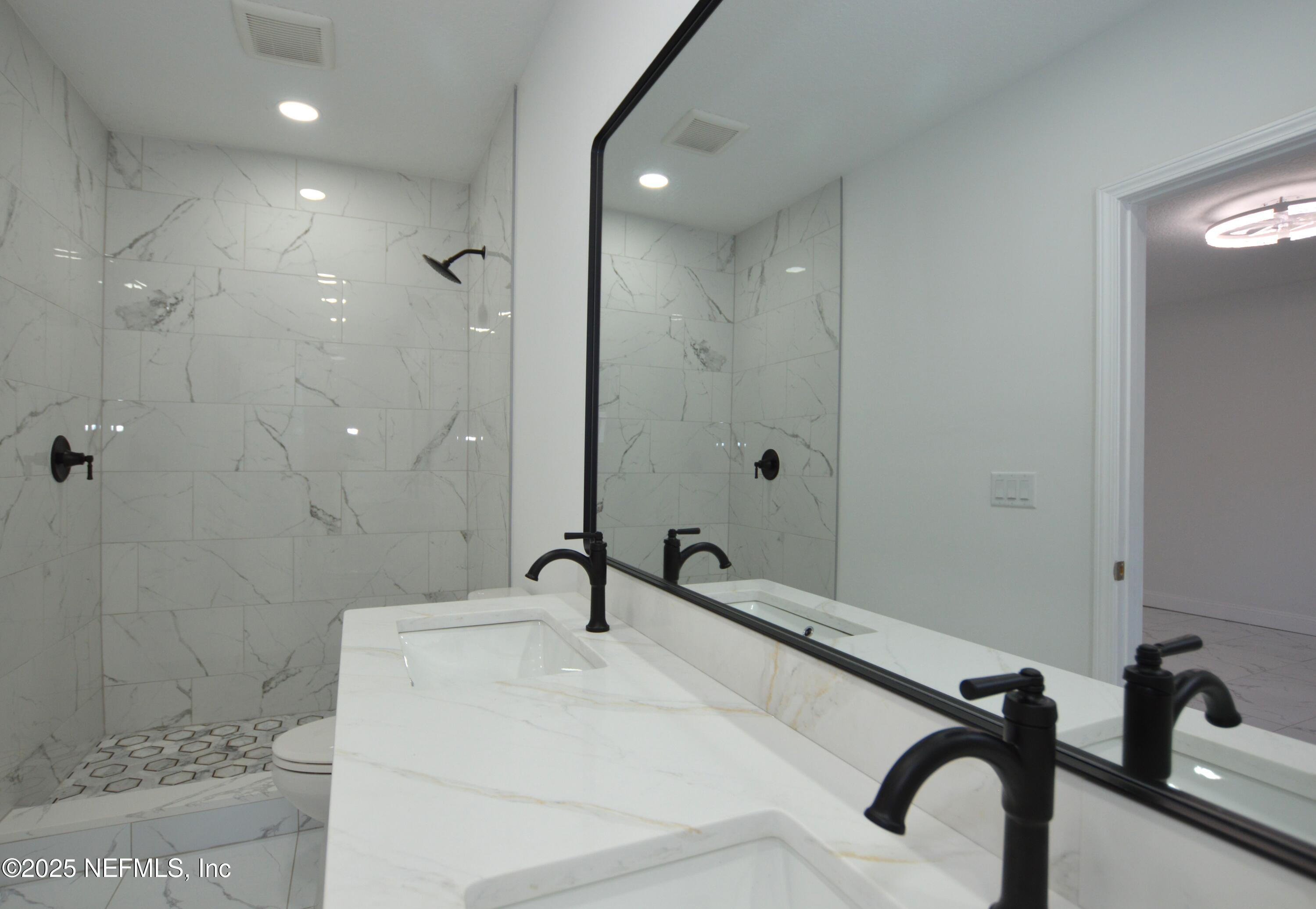 7941 Alderman Road Jacksonville, FL 32211 - Photo 30 of 40 a bathroom with a sink a toilet and a shower