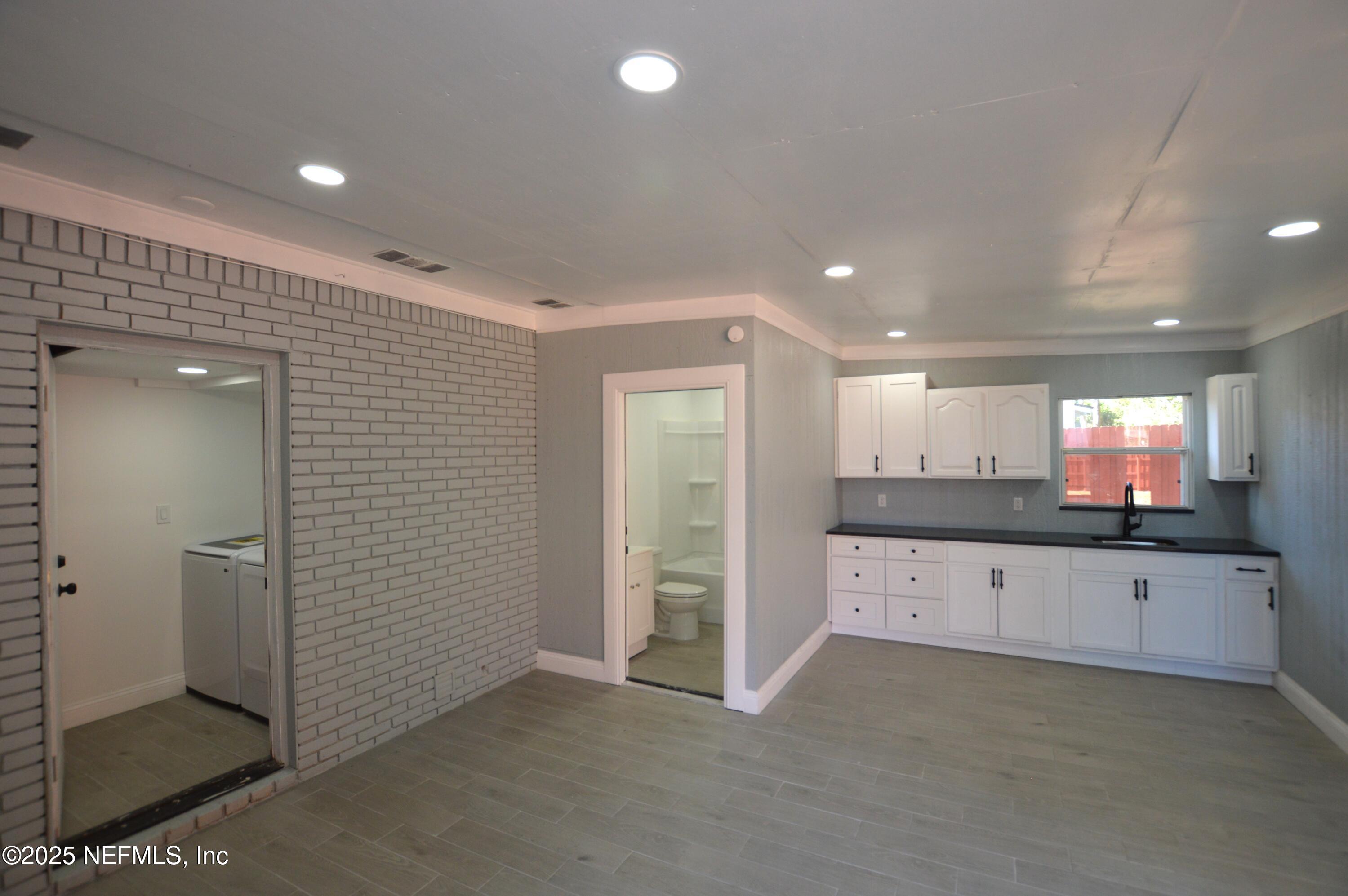 7941 Alderman Road Jacksonville, FL 32211 - Photo 31 of 40 a view of an empty room with a kitchen