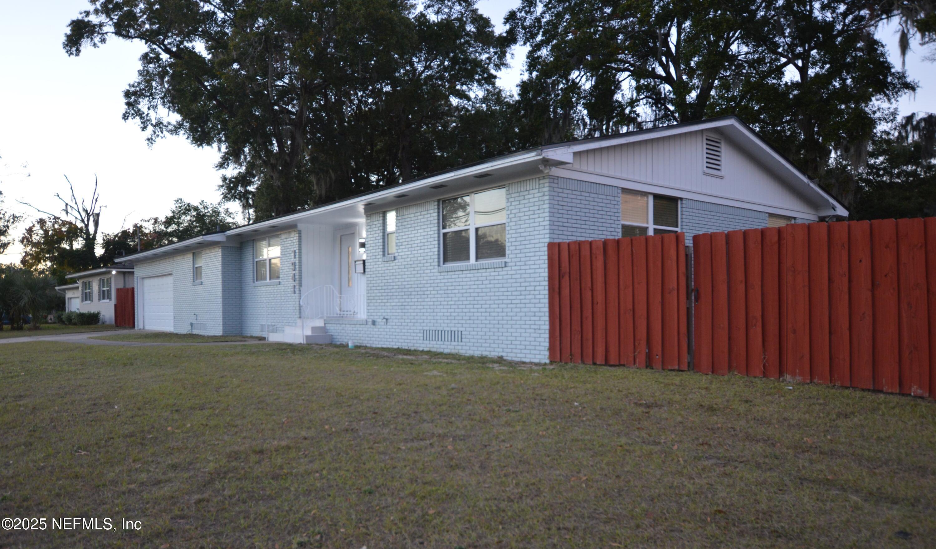 7941 Alderman Road Jacksonville, FL 32211 - Photo 38 of 40 a view of a small house with a yard