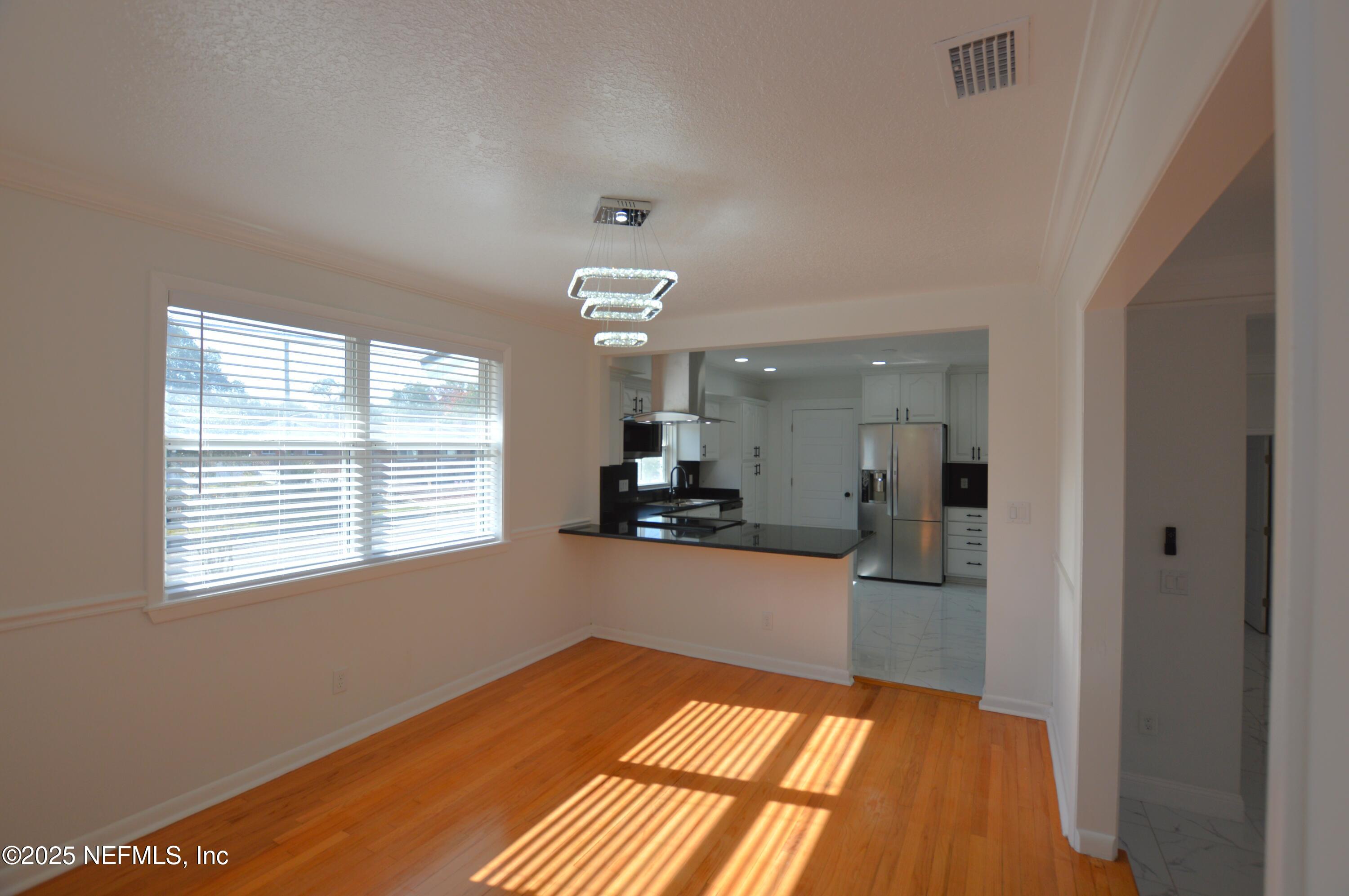 7941 Alderman Road Jacksonville, FL 32211 - Photo 6 of 40 a view of a living room with hardwood floor and a window