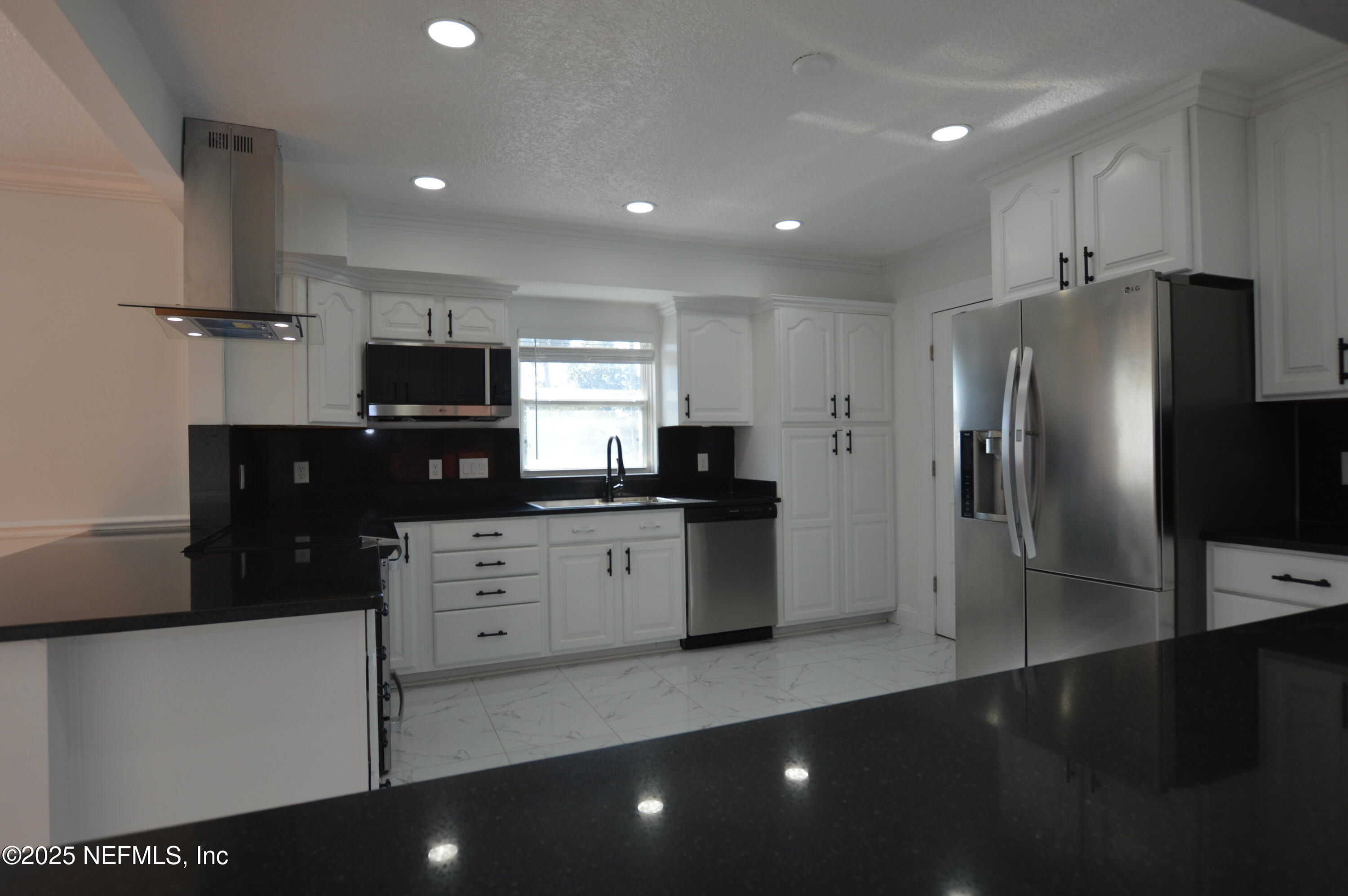7941 Alderman Road Jacksonville, FL 32211 - Photo 10 of 40 a kitchen with stainless steel appliances a refrigerator sink and microwave