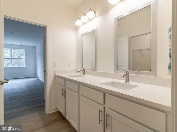 a bathroom with a double vanity sink and a mirror