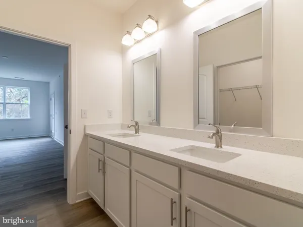 a bathroom with a double vanity sink and a mirror