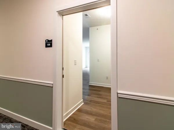 a view of a hallway with wooden floor
