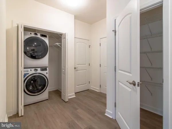 a view of a hallway with washer and dryer