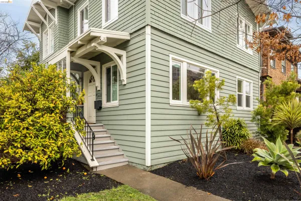 a front view of a house with a garden