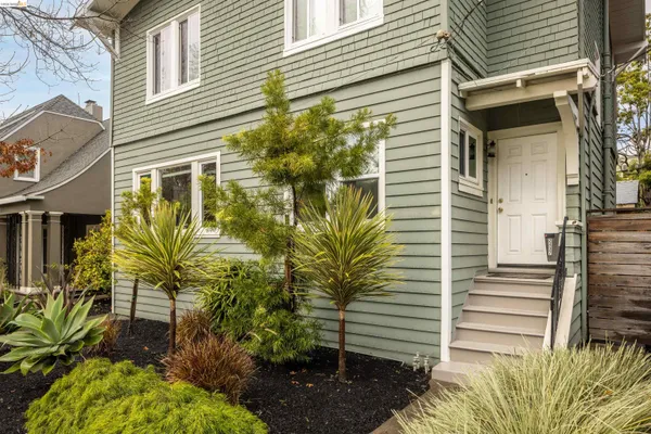 a view of a patio with couches and a fire pit and wooden fence