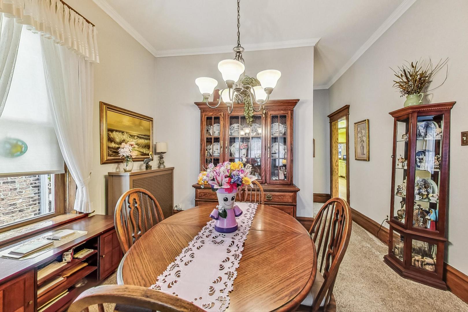 2954 South Loomis Street Chicago, IL 60608 - Photo 13 of 80 a view of a dining room with furniture wooden floor and chandelier