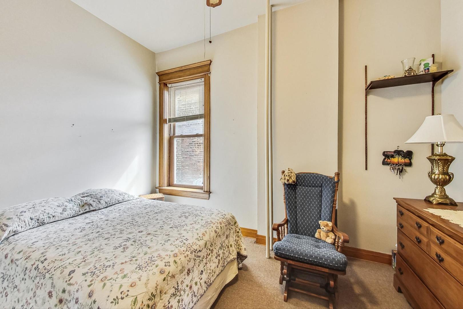 2954 South Loomis Street Chicago, IL 60608 - Photo 21 of 80 a bedroom with a bed and wooden floor