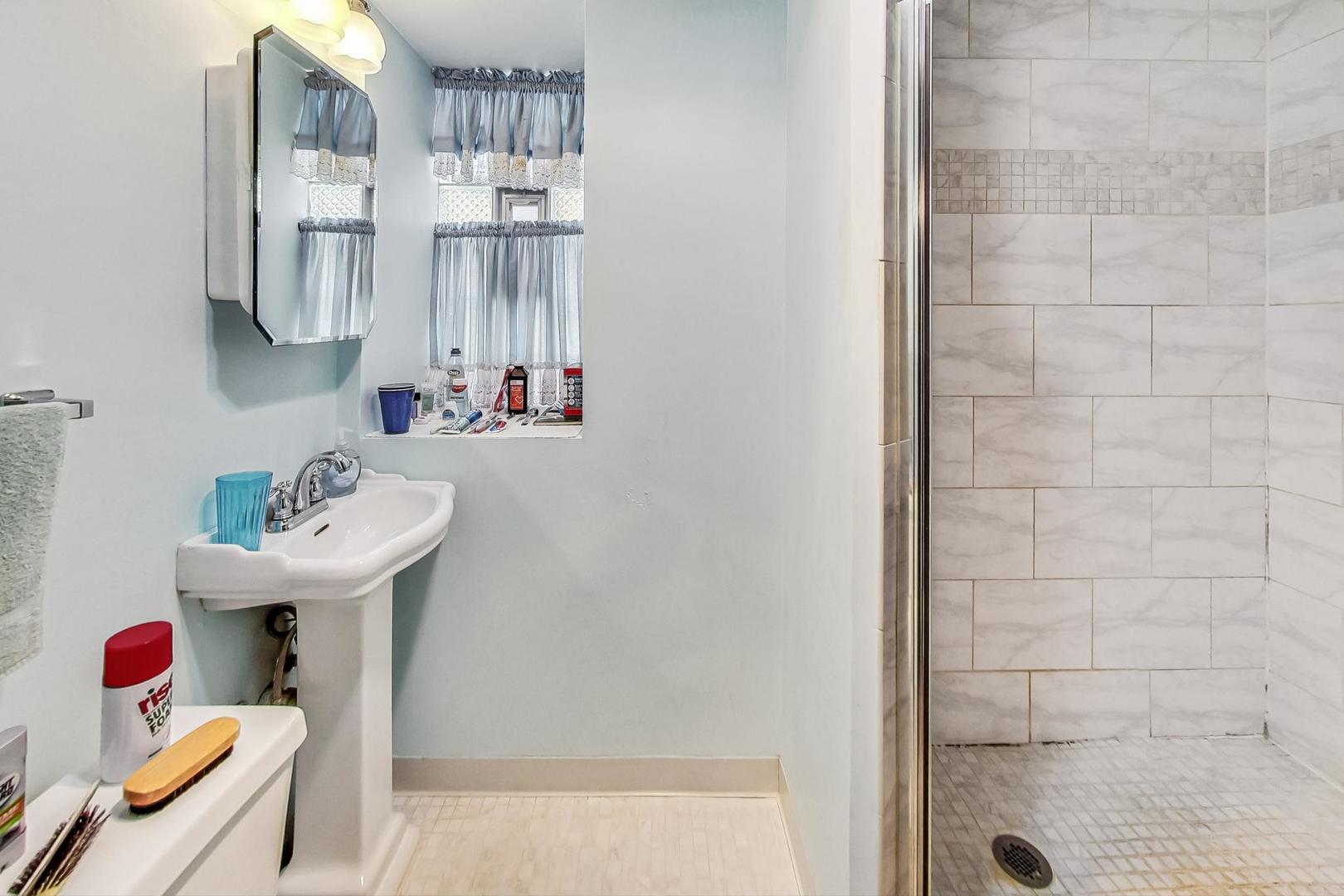 2954 South Loomis Street Chicago, IL 60608 - Photo 36 of 80 a bathroom with a sink and a mirror