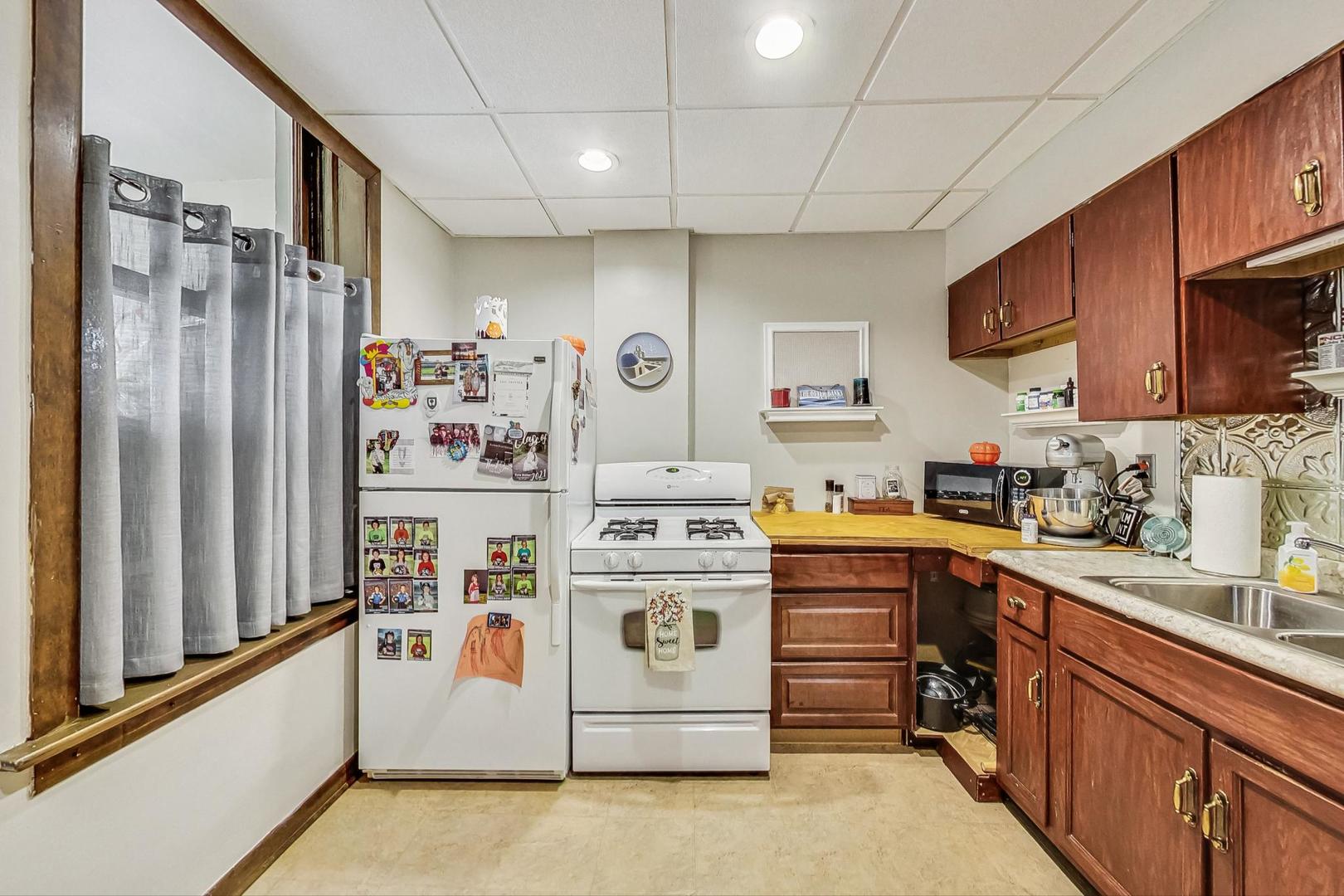 2954 South Loomis Street Chicago, IL 60608 - Photo 47 of 80 a kitchen with stainless steel appliances granite countertop a stove and a refrigerator