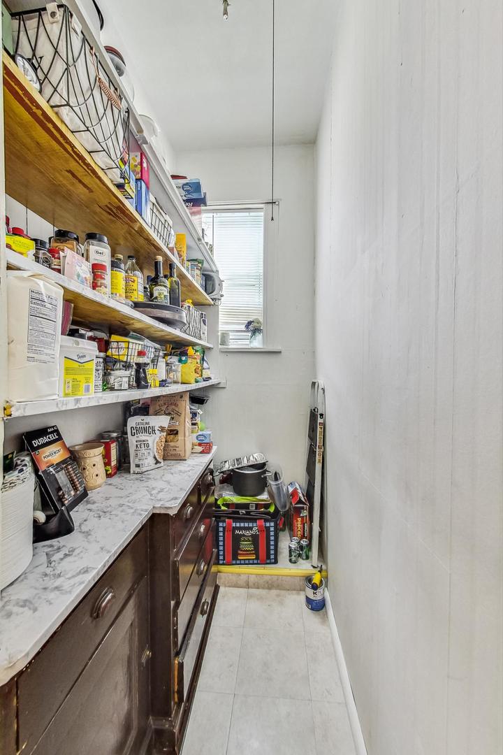 2954 South Loomis Street Chicago, IL 60608 - Photo 50 of 80 a storage room with stainless steel appliances granite countertop a sink and cabinets