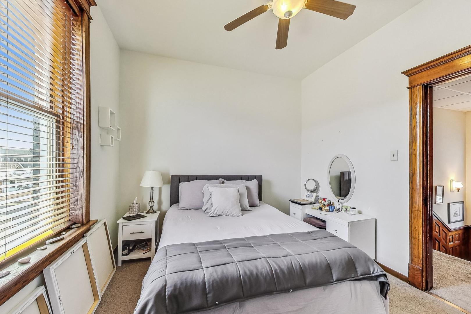 2954 South Loomis Street Chicago, IL 60608 - Photo 52 of 80 a bedroom with a bed and a large mirror next to a window