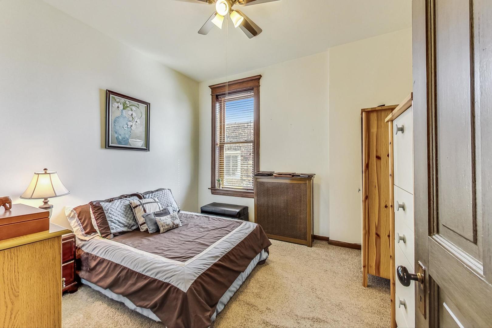 2954 South Loomis Street Chicago, IL 60608 - Photo 54 of 80 a bedroom with a bed and a chandelier