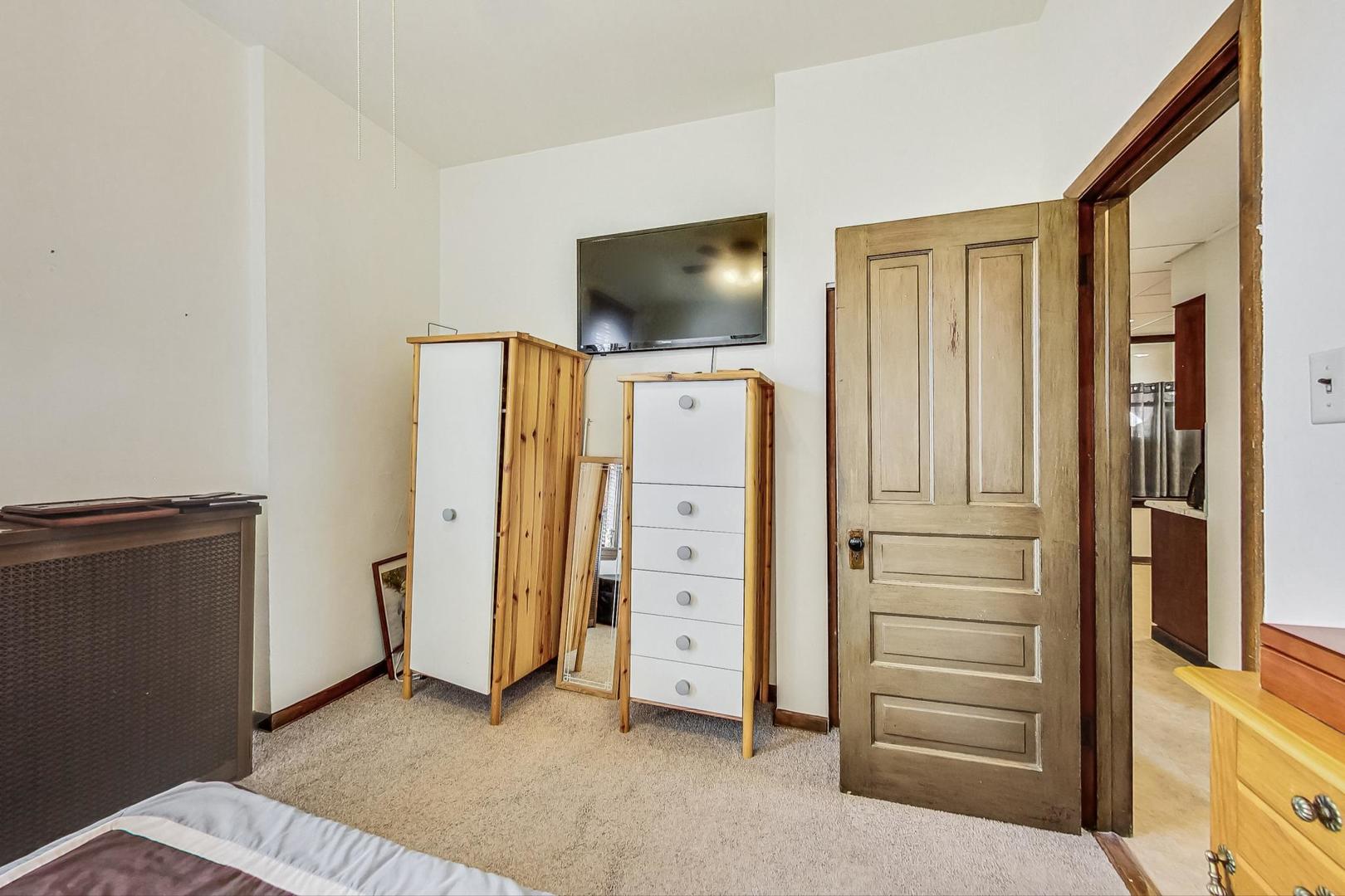 2954 South Loomis Street Chicago, IL 60608 - Photo 55 of 80 a view of room with flat screen tv and refrigerator