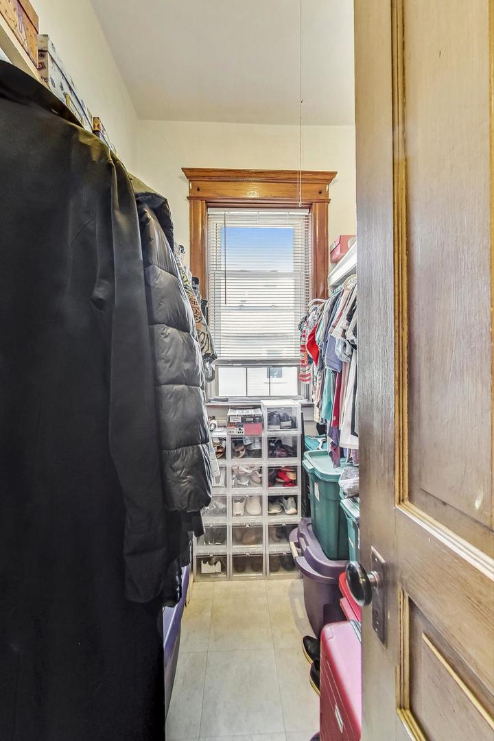 2954 South Loomis Street Chicago, IL 60608 - Photo 57 of 80 a view of walk in closet with clothes