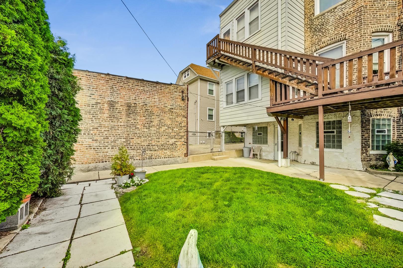 2954 South Loomis Street Chicago, IL 60608 - Photo 72 of 80 a front view of a house with a garden