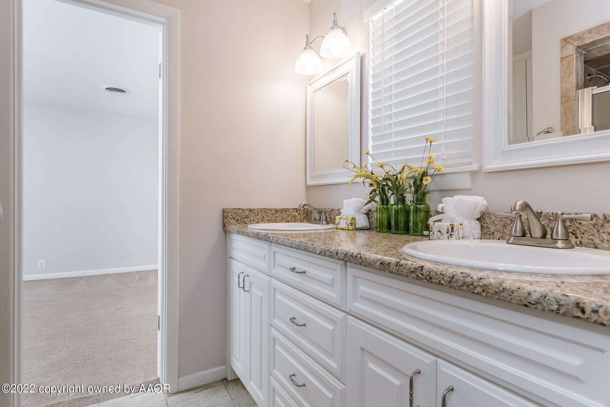 6107 Gainsborough Road Amarillo, TX 79106 - Photo 14 of 23 a bathroom with a granite countertop sink and a mirror