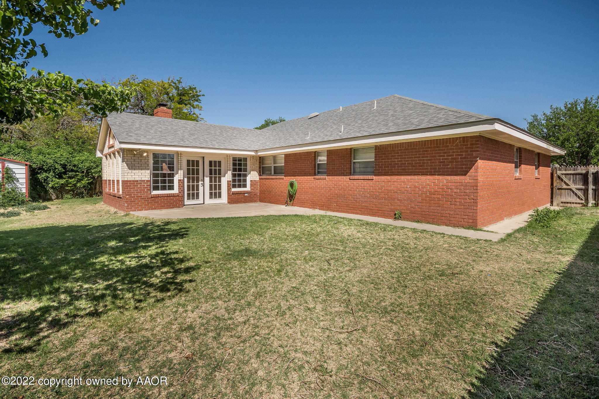 6107 Gainsborough Road Amarillo, TX 79106 - Photo 19 of 23 a front view of a house with a yard and trees