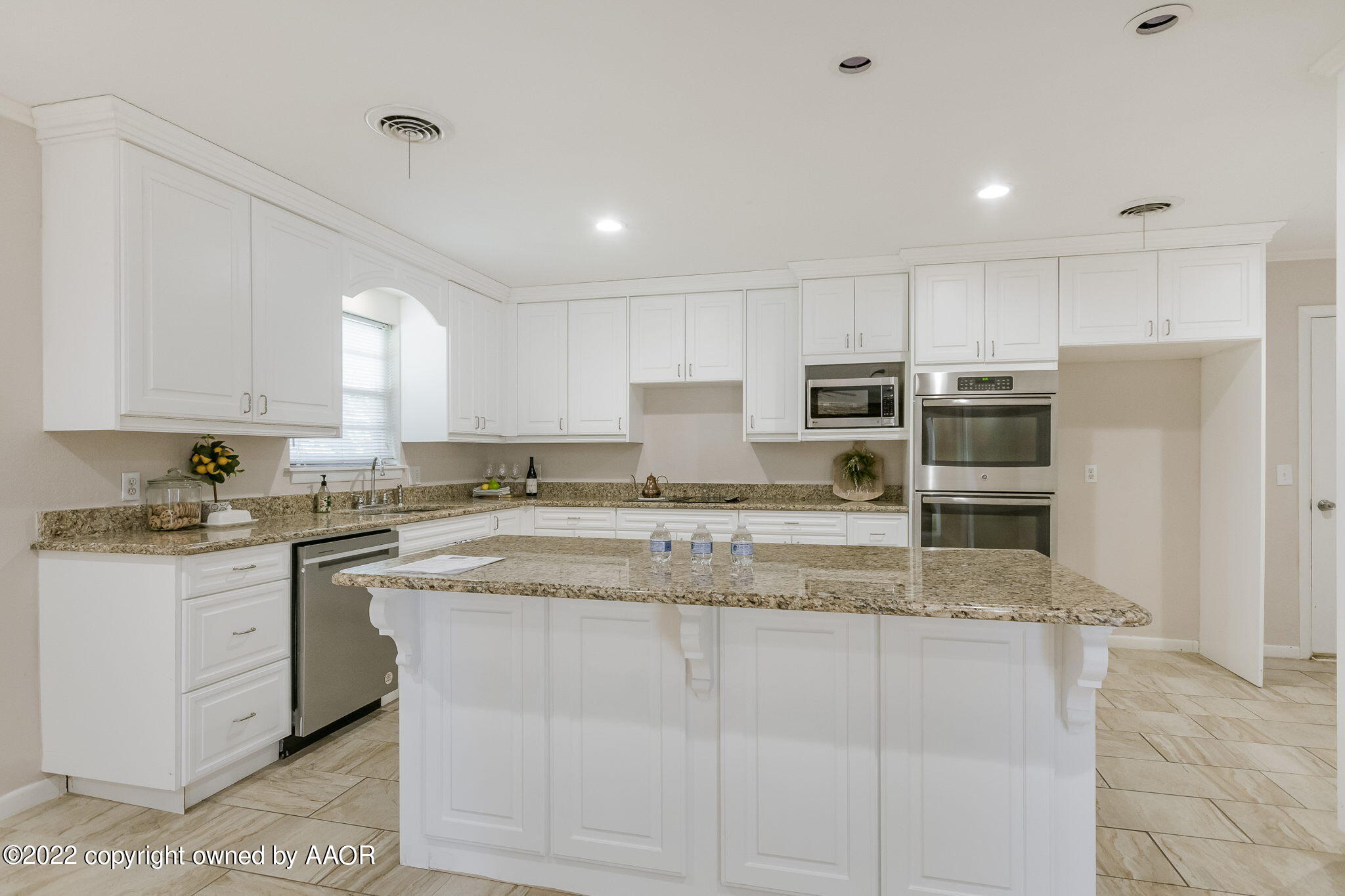 6107 Gainsborough Road Amarillo, TX 79106 - Photo 3 of 23 a kitchen with stainless steel appliances granite countertop a stove a sink and a refrigerator