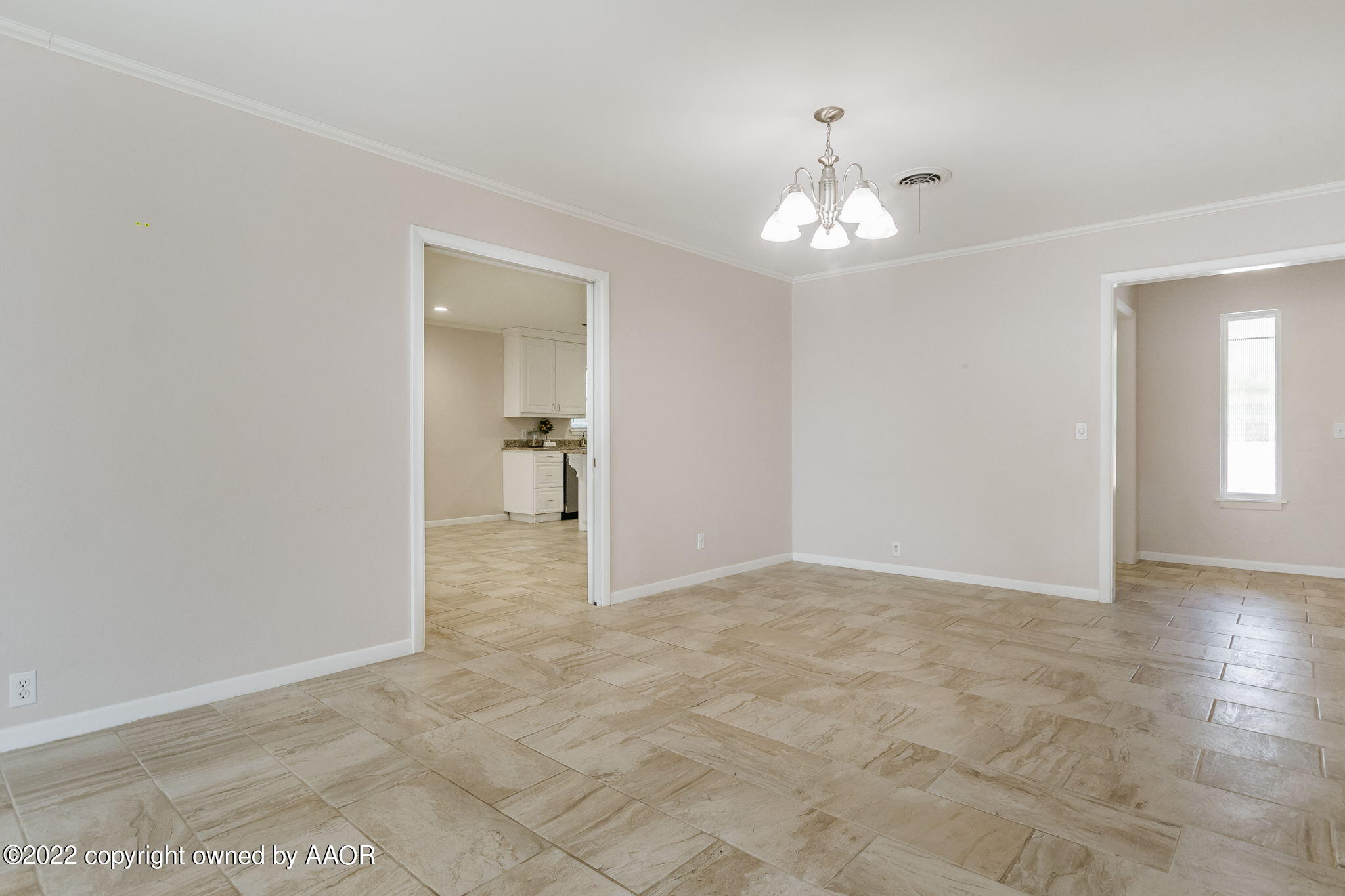 6107 Gainsborough Road Amarillo, TX 79106 - Photo 8 of 23 wooden floor in an empty room with a window