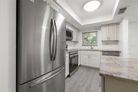 a kitchen with a refrigerator stove and sink
