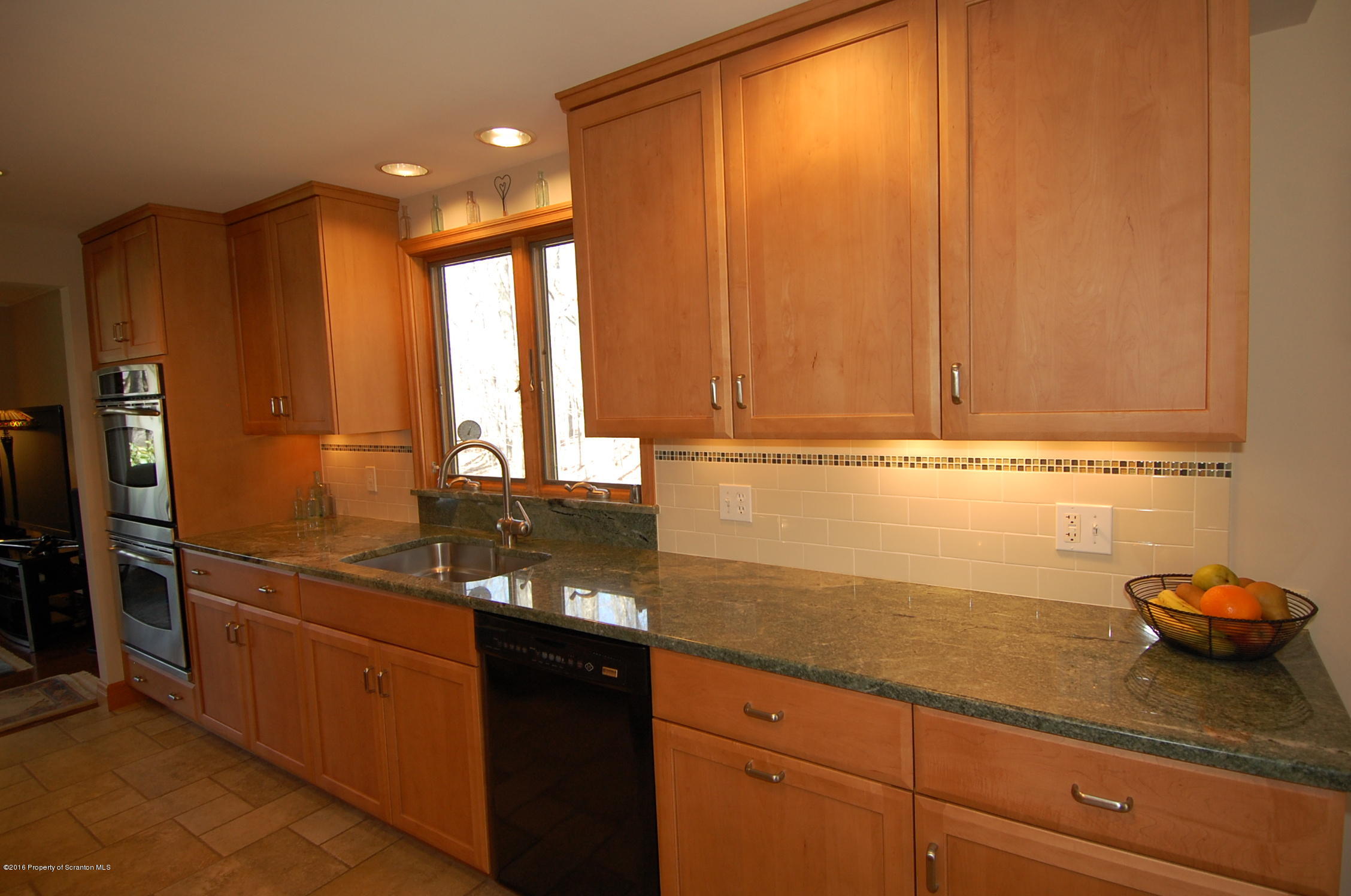 60 Tinker Brook Road Forest City, PA 18421 - Photo 28 of 62 a kitchen with granite countertop a sink and a refrigerator