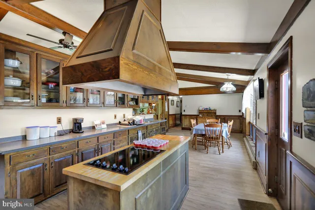 a kitchen with stainless steel appliances a stove a sink dishwasher and cabinets with wooden floor