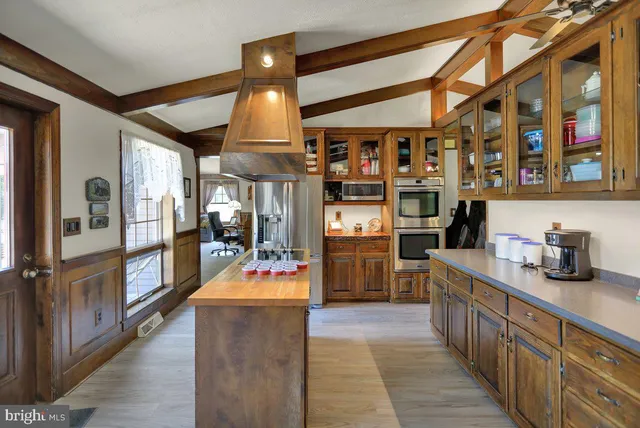 a kitchen with stainless steel appliances granite countertop a refrigerator and stove