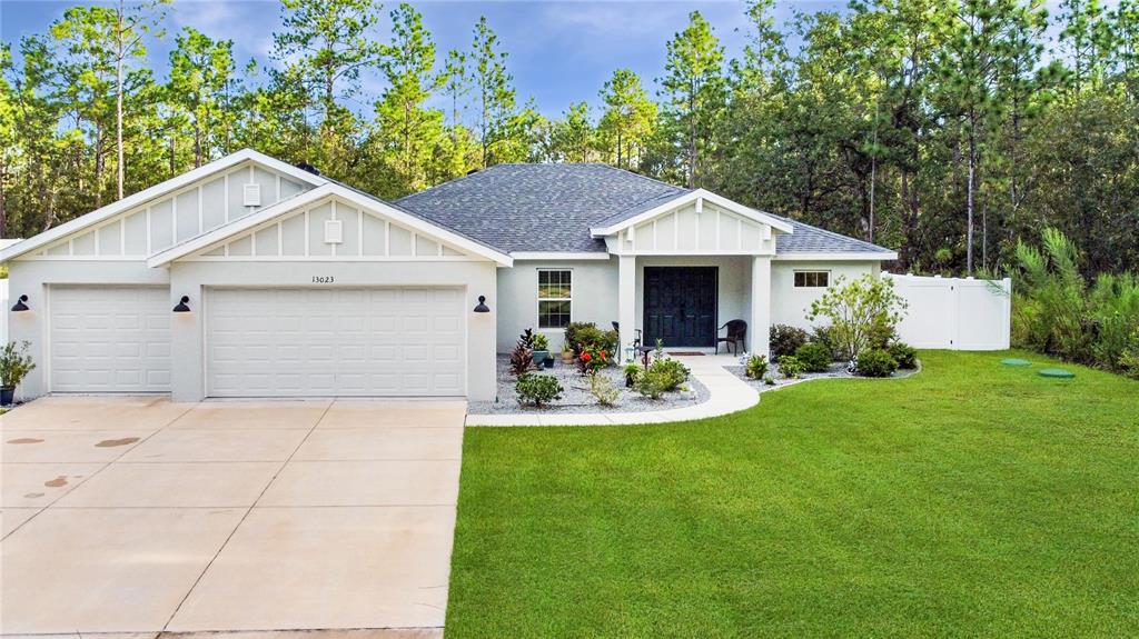 13023 Downy Woodpecker Road Weeki Wachee, FL 34614 - Photo 1 of 43 a front view of house with yard and green space