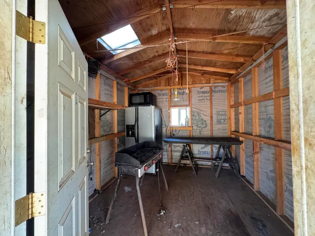 a view of a barn in the middle of a yard