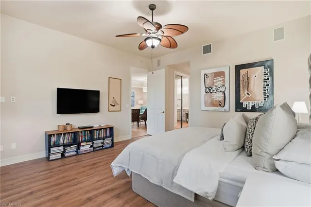 a bedroom with a bed window and a flat screen tv