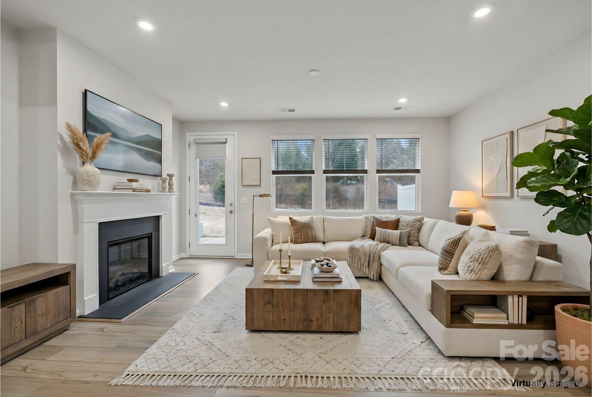11246 Bartrams Way Charlotte, NC 28278 - Photo 12 of 31 a living room with furniture and a fireplace