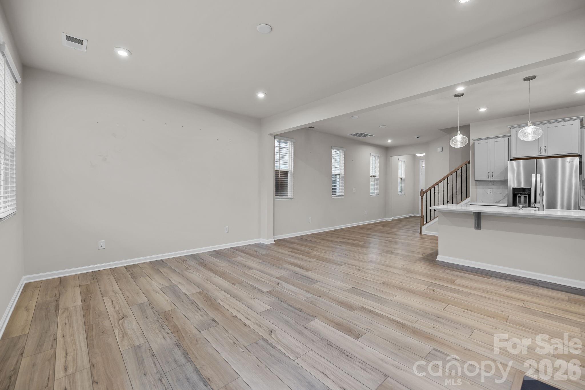 11246 Bartrams Way Charlotte, NC 28278 - Photo 15 of 31 a view of an empty room with wooden floor