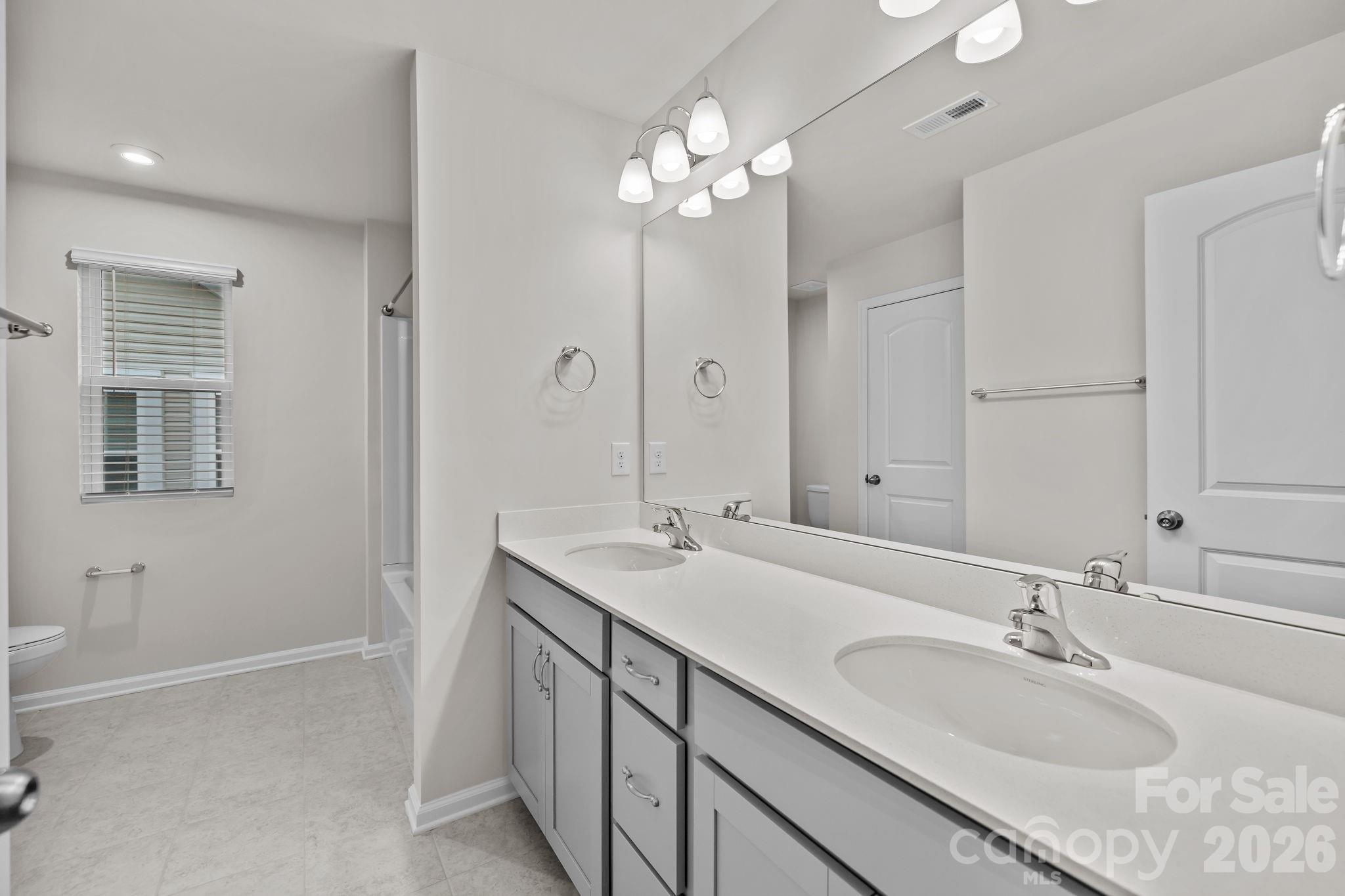 11246 Bartrams Way Charlotte, NC 28278 - Photo 18 of 31 a bathroom with a sink double vanity and a mirror