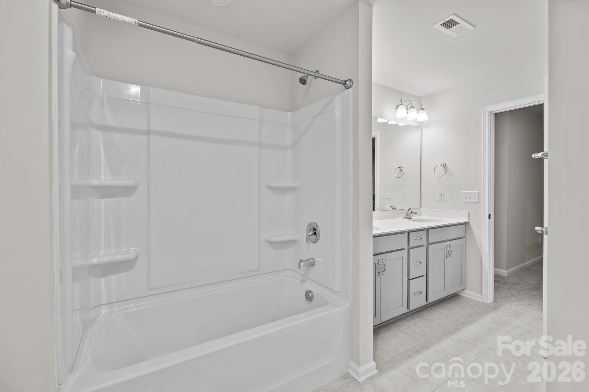 11246 Bartrams Way Charlotte, NC 28278 - Photo 19 of 31 a bathroom with a tub shower vanity and a sink