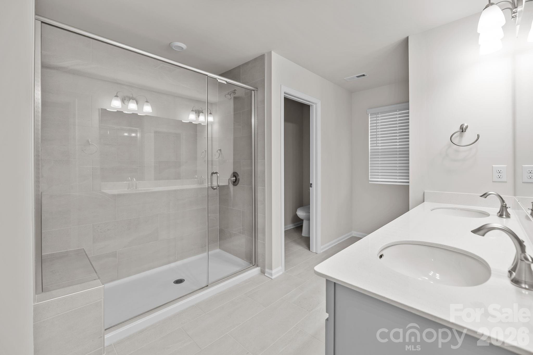 11246 Bartrams Way Charlotte, NC 28278 - Photo 23 of 31 a bathroom with a sink a toilet and shower