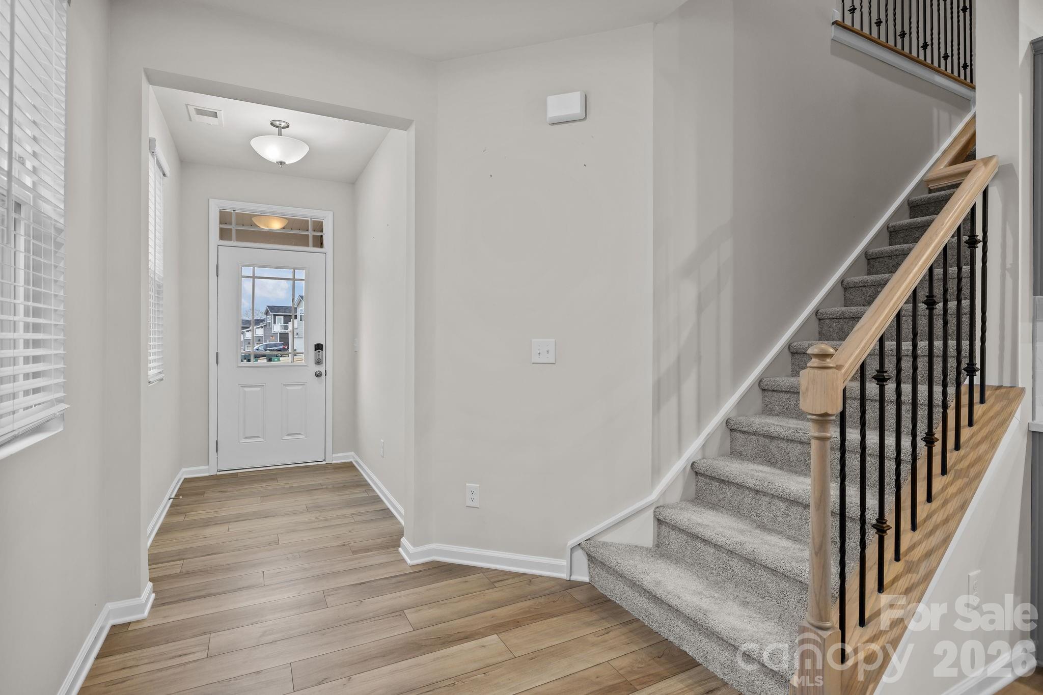 11246 Bartrams Way Charlotte, NC 28278 - Photo 4 of 31 a view of a hallway with wooden floor and entryway