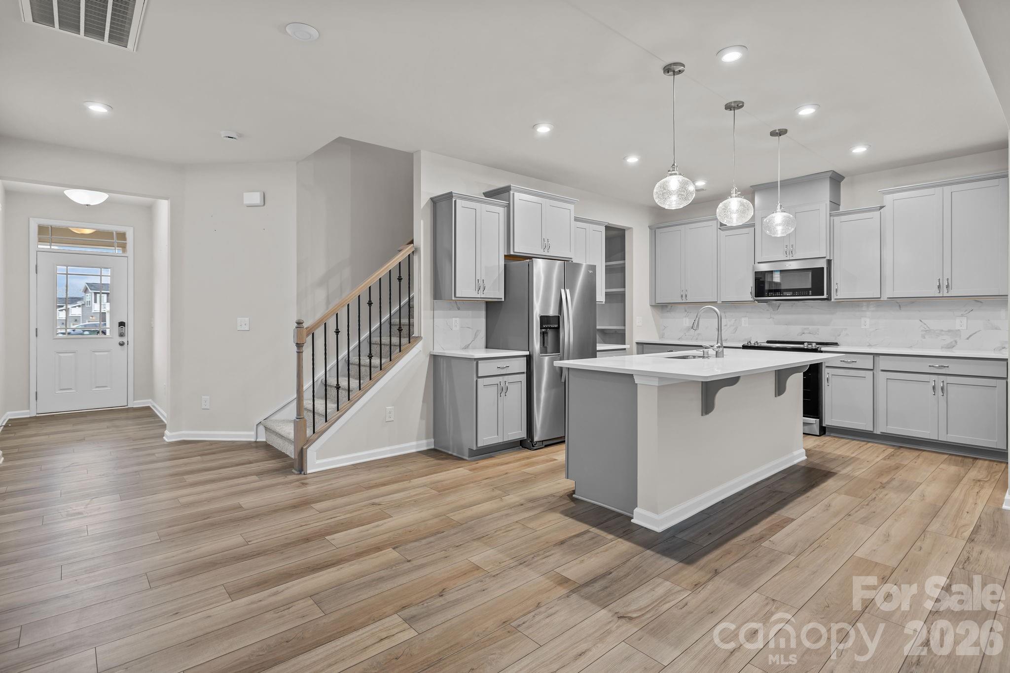 11246 Bartrams Way Charlotte, NC 28278 - Photo 6 of 31 a kitchen with stainless steel appliances a sink and a refrigerator