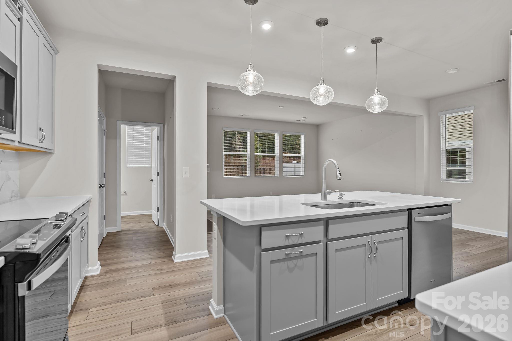 11246 Bartrams Way Charlotte, NC 28278 - Photo 8 of 31 a kitchen with a sink and stove