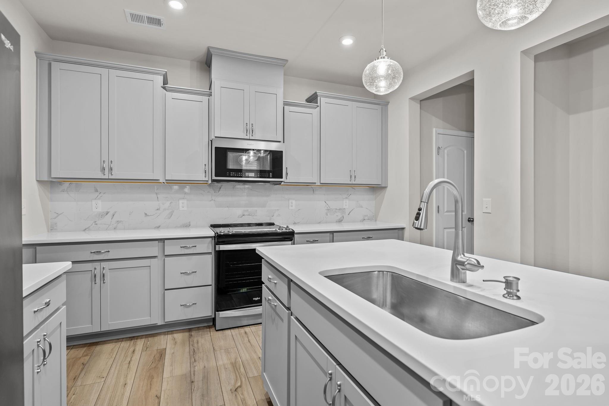 11246 Bartrams Way Charlotte, NC 28278 - Photo 10 of 31 a kitchen with granite countertop a sink and cabinets