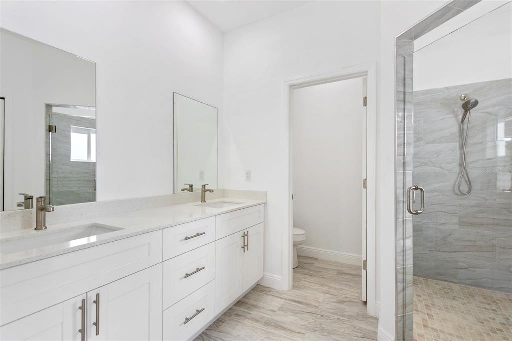 3121 Gardenia Drive Indian Lake Estates, FL 33855 - Photo 12 of 55 a bathroom with a double vanity sink mirror and shower