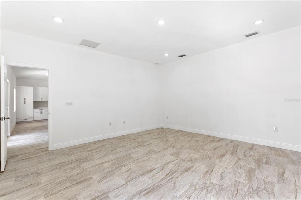 3121 Gardenia Drive Indian Lake Estates, FL 33855 - Photo 13 of 55 an empty room with wooden floor and bathroom
