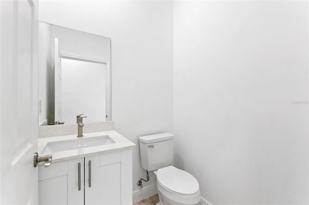 3121 Gardenia Drive Indian Lake Estates, FL 33855 - Photo 17 of 55 a bathroom with a sink a toilet and mirror