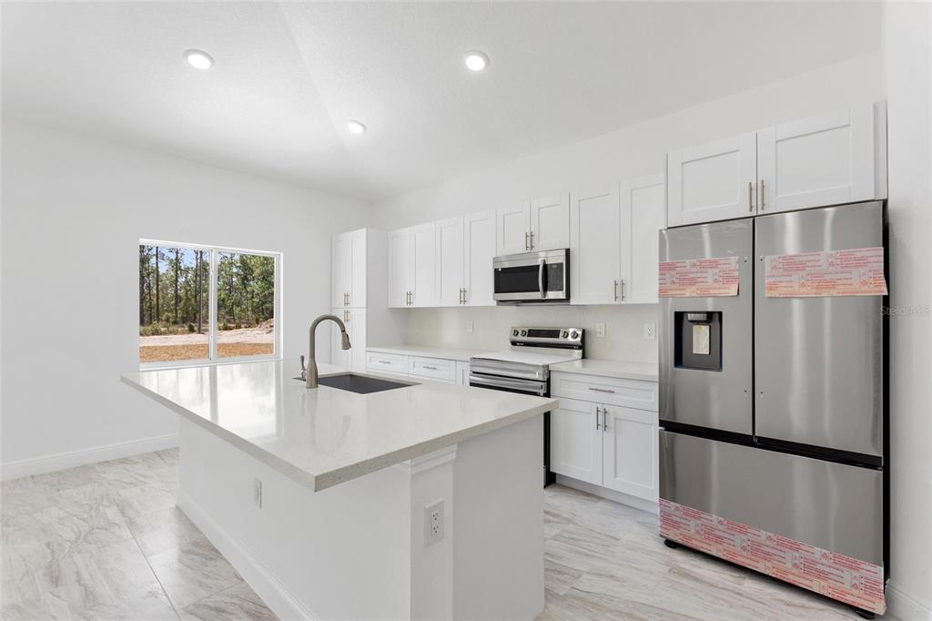 3121 Gardenia Drive Indian Lake Estates, FL 33855 - Photo 2 of 55 a kitchen with stainless steel appliances a refrigerator sink and microwave