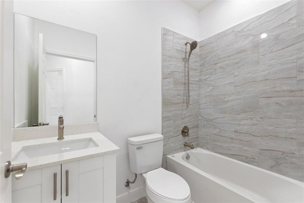 3121 Gardenia Drive Indian Lake Estates, FL 33855 - Photo 22 of 55 a bathroom with a sink a toilet and bathtub