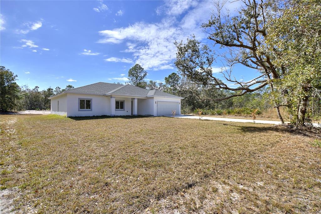 3121 Gardenia Drive Indian Lake Estates, FL 33855 - Photo 23 of 55 a front view of a house with a yard